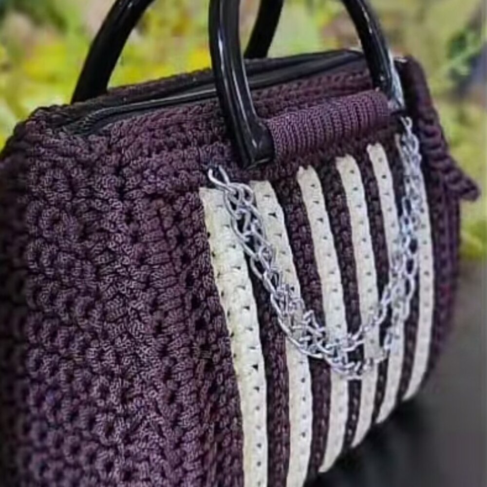 A royal blue and cream crochet handbag handmade by a mother in our caregiver livelihood program